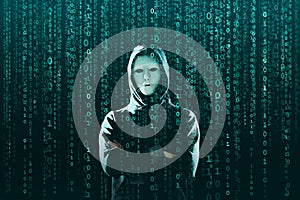 Computer hacker in mask and hoodie over abstract binary background. Obscured dark face. Data thief, internet fraud