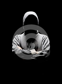 Computer hacker in white mask and hoodie. Obscured dark face. Data thief, internet fraud, darknet and cyber security