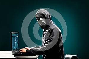 Computer hacker in white mask and hoodie. Obscured dark face. Data thief, internet fraud, darknet and cyber security