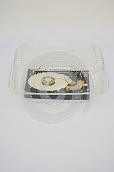 Computer hard disc into transparent plastic container