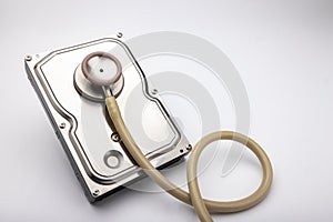 Computer hard disk and stethoscope on white background , Checking Security concept