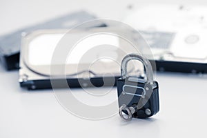 Computer hard disks and metal padlock with key concept for encrypted data, cyber security