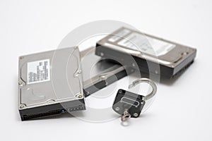 Computer hard disks and open metal padlock concept for encrypted data, cyber security on white background