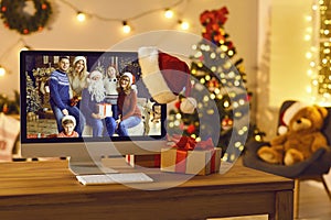 Computer with image of happy family reunited for Christmas set as desktop background