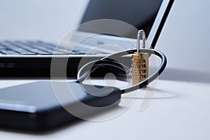 Computer or internet security. Data protection concept: external hard drive, lock and laptop on the background