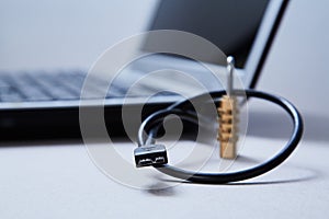 Computer or internet security. Data protection concept: usb cable, lock and laptop in the background