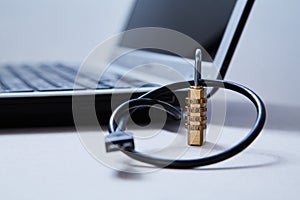 Computer or internet security. Data protection concept: usb cable, lock and laptop in the background