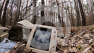 Computer in a junkyard in the forest