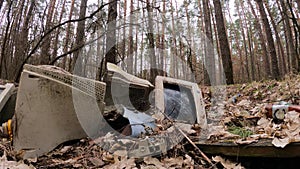 Computer in a junkyard in the forest