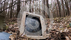 Computer in a junkyard in the forest