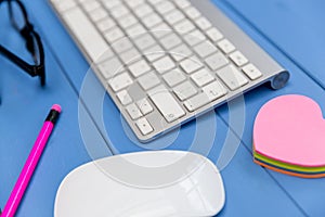 Computer keyboard on blue background minimal office concept