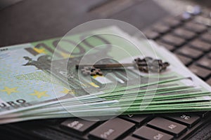 Computer keyboard with euro banknotes and vintage key. Business Success concept