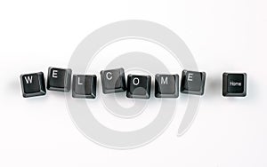 Computer keyboard keys spelling Welcome Home, isolated on white background