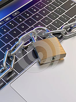 Computer keyboard locked with padlock and chain - security