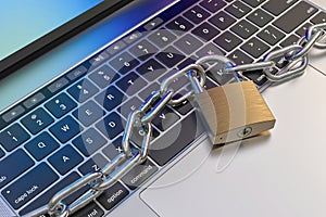 Computer keyboard locked with padlock and chain - security
