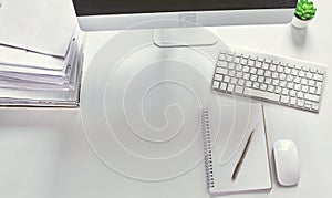 Computer keyboard, mouse and notebook with a pencil on the table