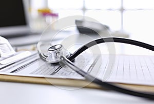 Computer keyboard, mouse and notebook with a pencil on the table