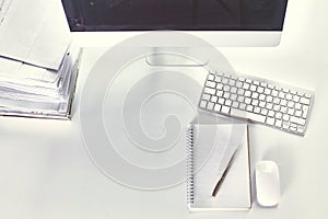 Computer keyboard, mouse and notebook with a pencil on the table