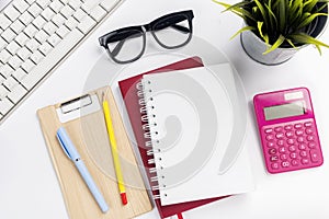 Computer keyboard and note book with pen and pencil