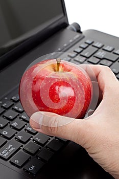 Computer Keyboard and red apple