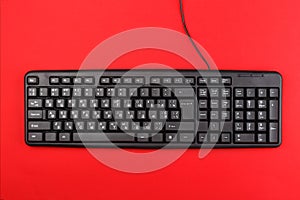 Computer keyboard on a red background