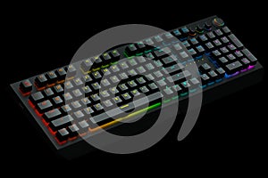 Computer keyboard with rgb colors isolated on black background.