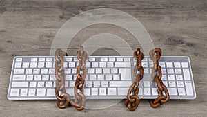 Computer keyboard tied with rusty chain