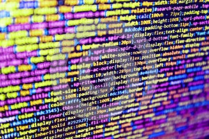 Computer language script code screen. Digital technology modern background. HTML CSS3 source code on lcd screen with black