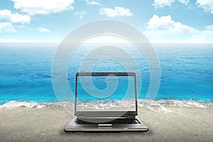 Computer laptop on the beach