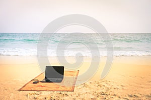 Computer laptop at the beach on tropical destination