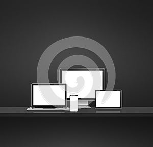 Computer, laptop, mobile phone and digital tablet pc. Black shelf background