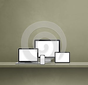 Computer, laptop, mobile phone and digital tablet pc. green shelf background