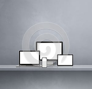 Computer, laptop, mobile phone and digital tablet pc. Grey shelf background