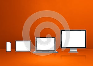 computer  laptop  mobile phone and digital tablet pc. orange background