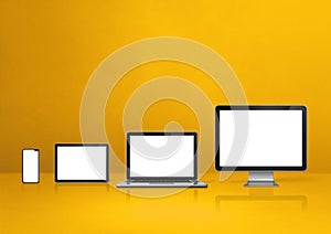 Computer, laptop, mobile phone and digital tablet pc. yellow background