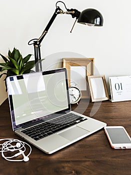 Computer laptop mockup mobile earphones wooden table