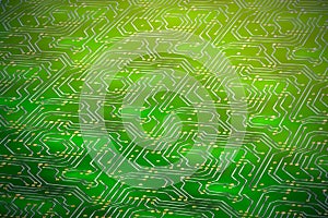 Computer microchip with golden contacts on green motherboard in perspective