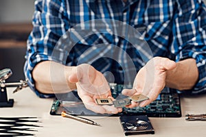 Computer microchips in male hands, close-up
