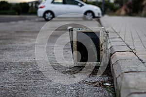 Computer monitor abandoned on the street. planned obsolescence concept. Selective focus