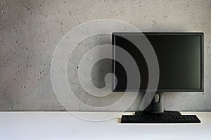 Computer monitor with blank black screen on the desk with copy space.