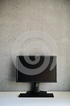 Computer monitor with blank black screen on the desk with copy space.