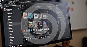 Computer Monitor Displaying App Icons and User Interface in Office Setting