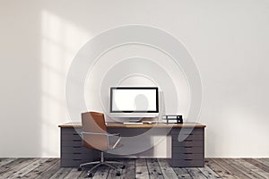 Computer monitor in room with gray and brown table