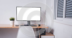 Computer monitor with white blank screen on the business desk