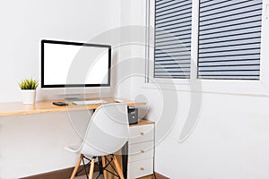 Computer monitor with white blank screen on the business desk