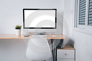 Computer monitor with white blank screen on the business desk