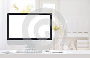 Computer monitor with white screen on desk in modern office