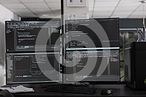 Computer monitors on desk compiling programming html data