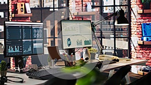 Computer monitors on office desk showing data analytics dashboards photo