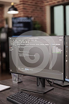 Computer monitors showing source code